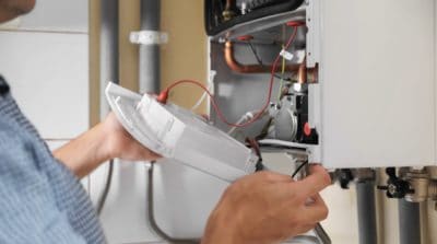 person fixing  gas boiler