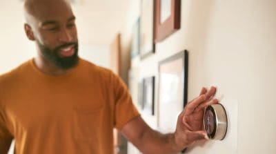 man altering thermostat